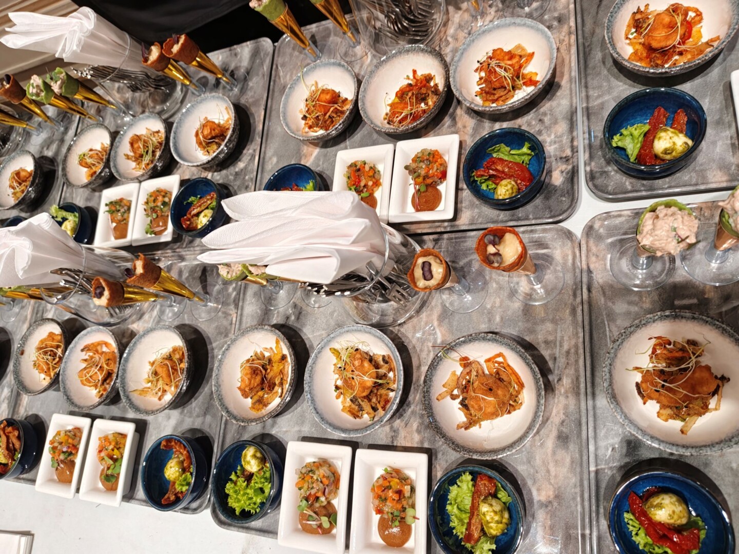 Gourmet appetizers served on marble platters, catering event food.